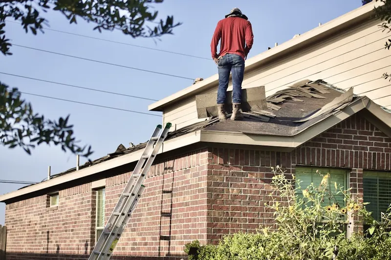 Professional roofer working on a residential roof in East Rutherford